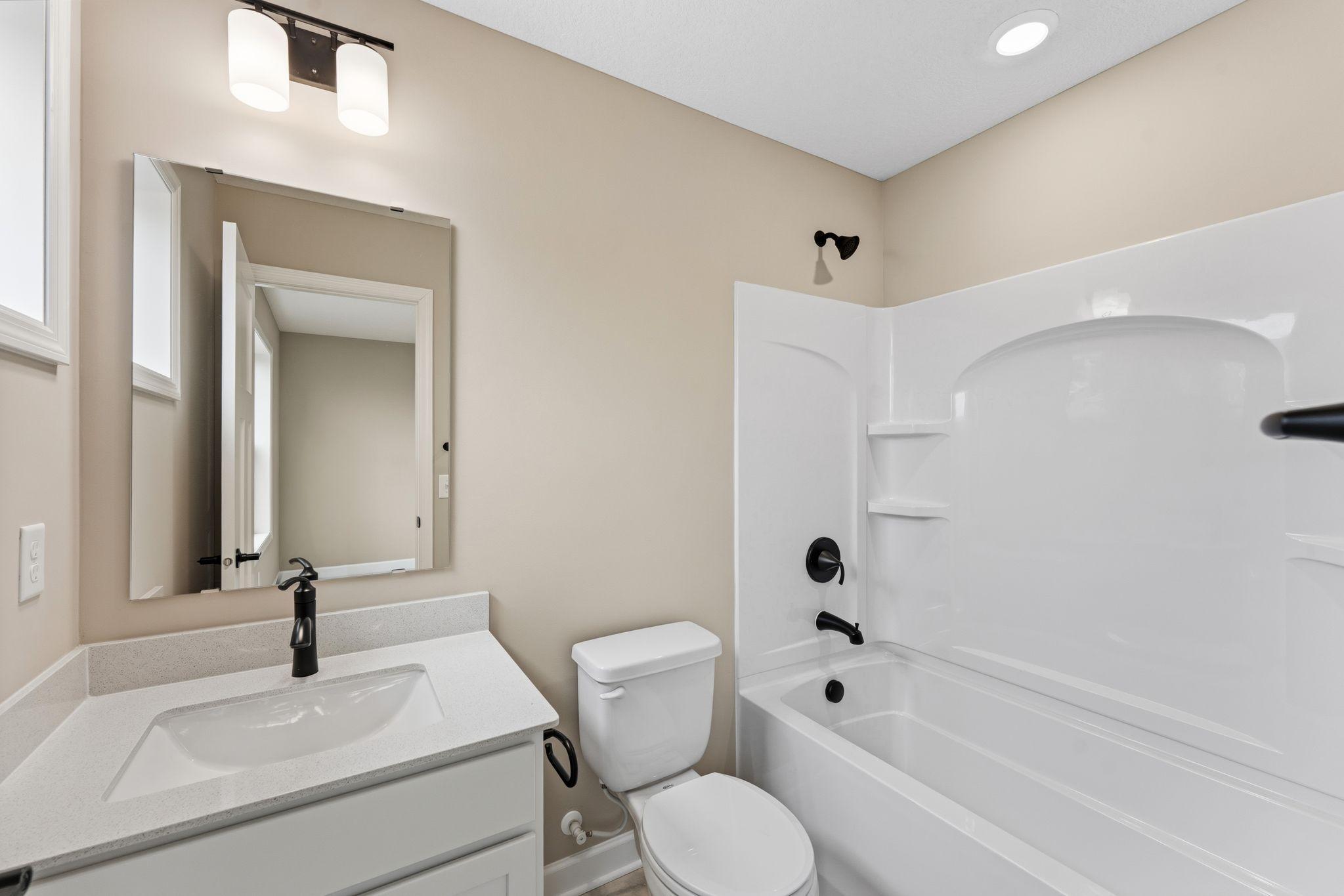 This secondary bedroom ensuite bath promotes a streamlined morning routine
