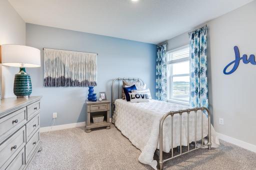 One of three secondary bedrooms upstairs with plenty of natural light in each. *Pictures are of a model home, actual colors and finishes may vary.