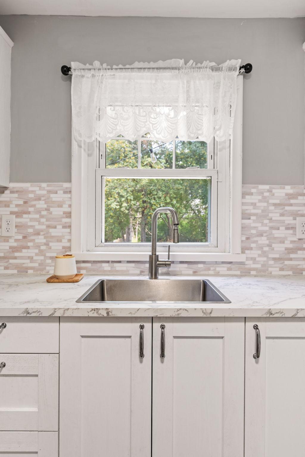 Kitchen window overlooks the backyard and brings in plenty of natural light.