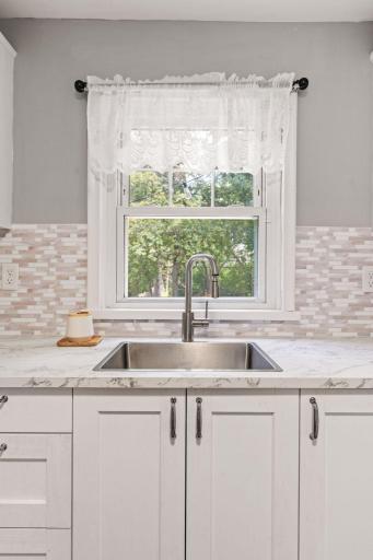 Kitchen window overlooks the backyard and brings in plenty of natural light.
