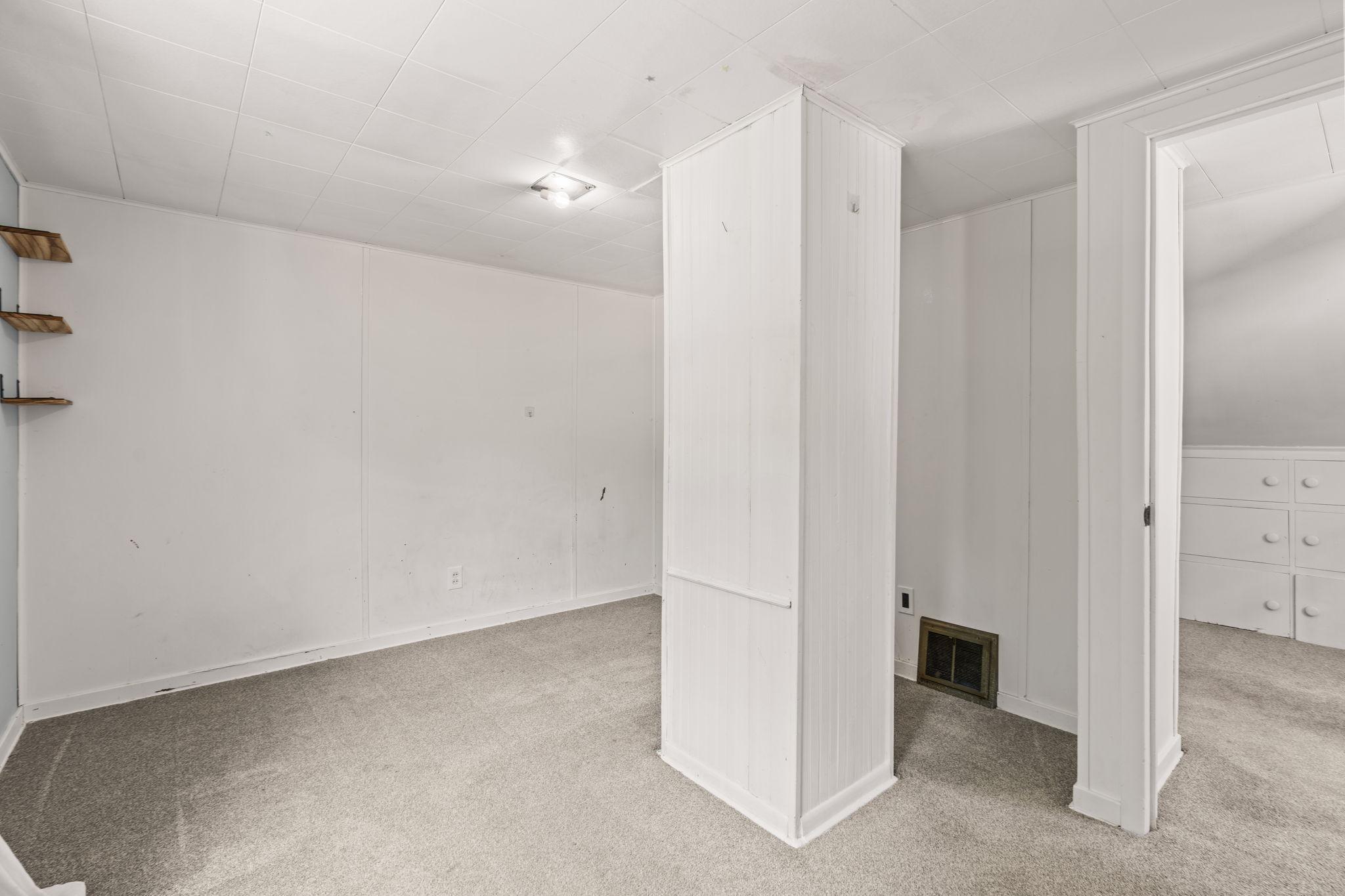 Spacious upper-level room with flexible furniture arrangements.