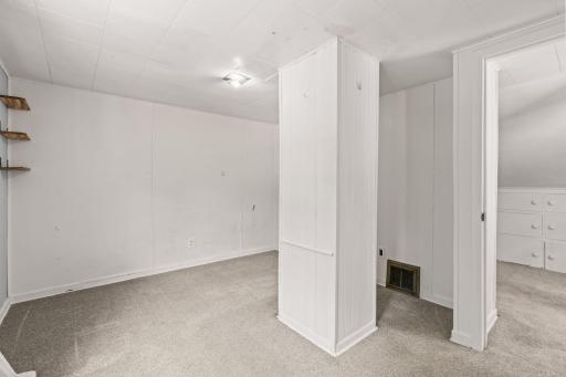 Spacious upper-level room with flexible furniture arrangements.
