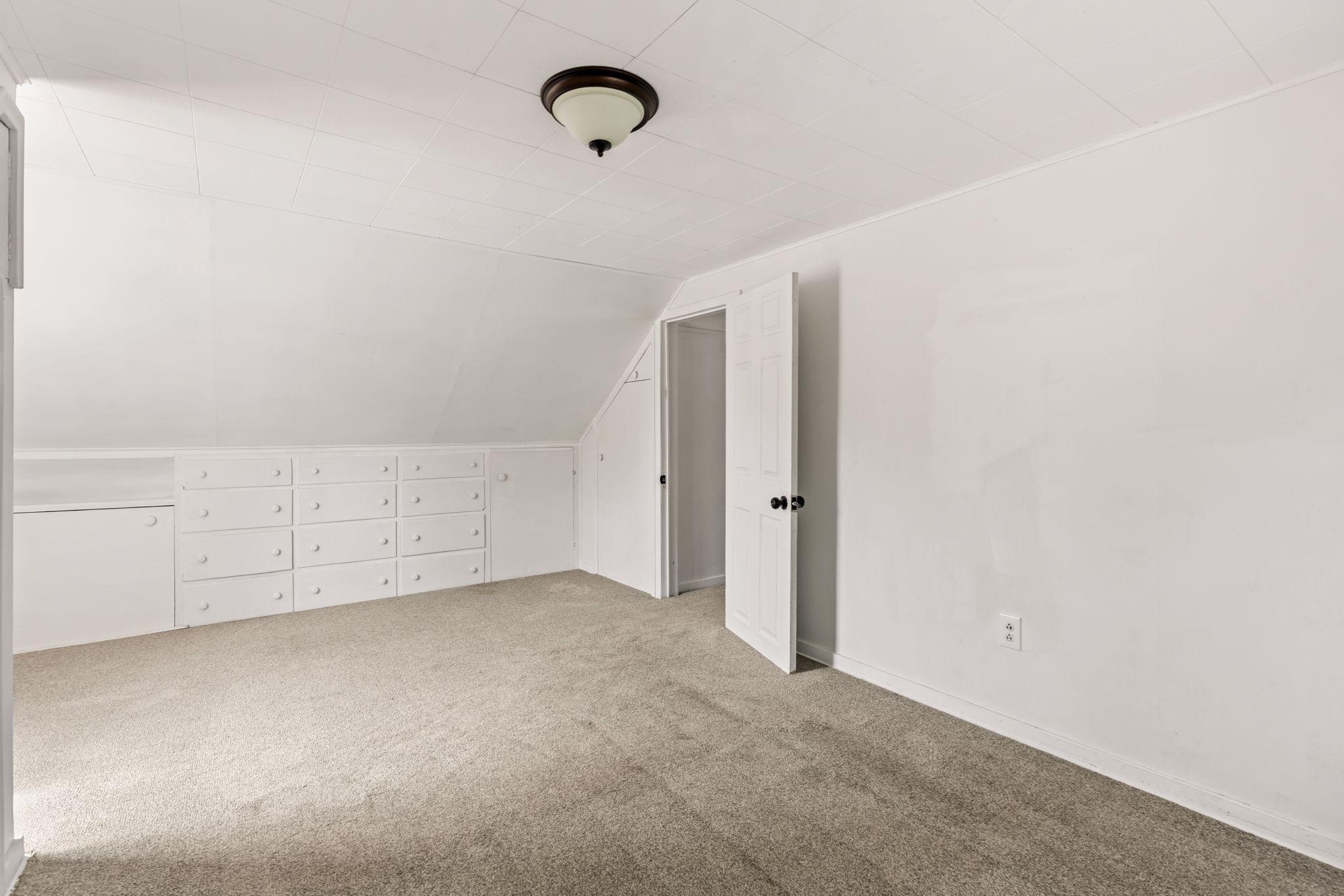 Upper room with built-in drawers provide convenient storage without sacrificing floor space.