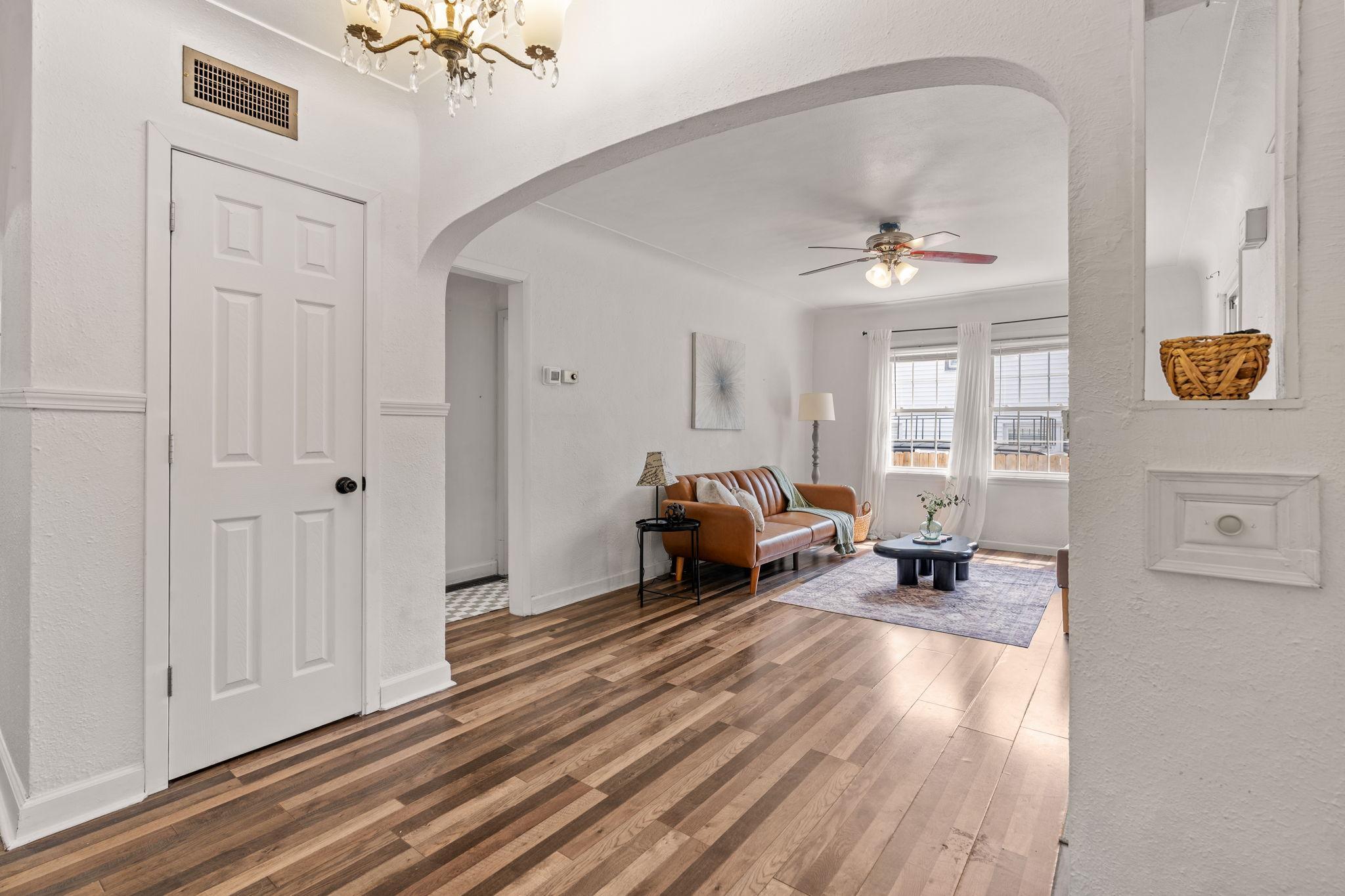 Arched doorway adds charm and character between the living and dining areas.