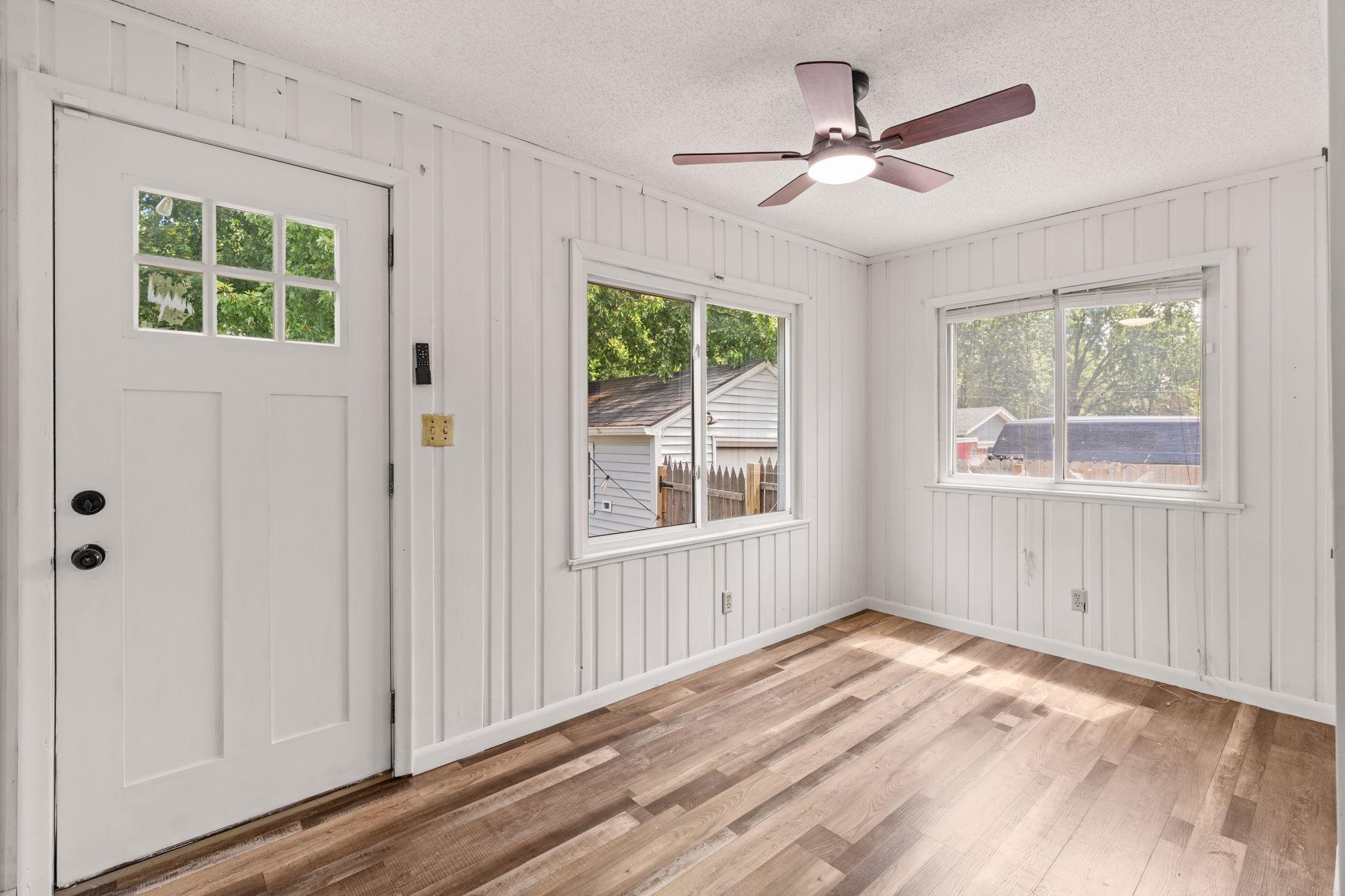 Versatile sun room with multiple windows and direct outdoor access.