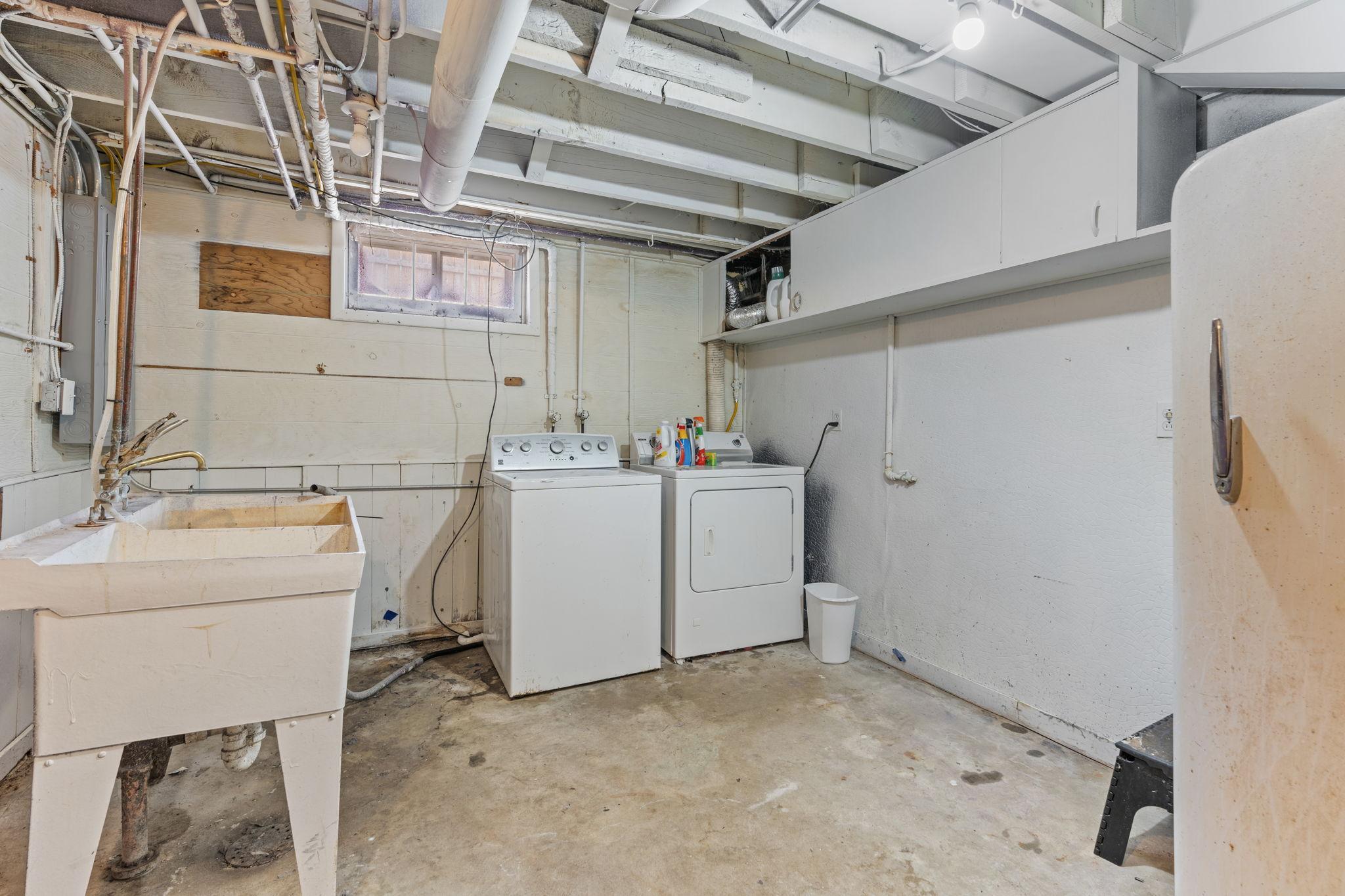 Dedicated laundry and utility area with a new furnace, new water heater, and new electrical panel.