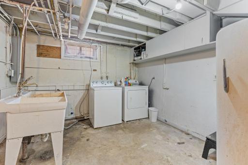 Dedicated laundry and utility area with a new furnace, new water heater, and new electrical panel.