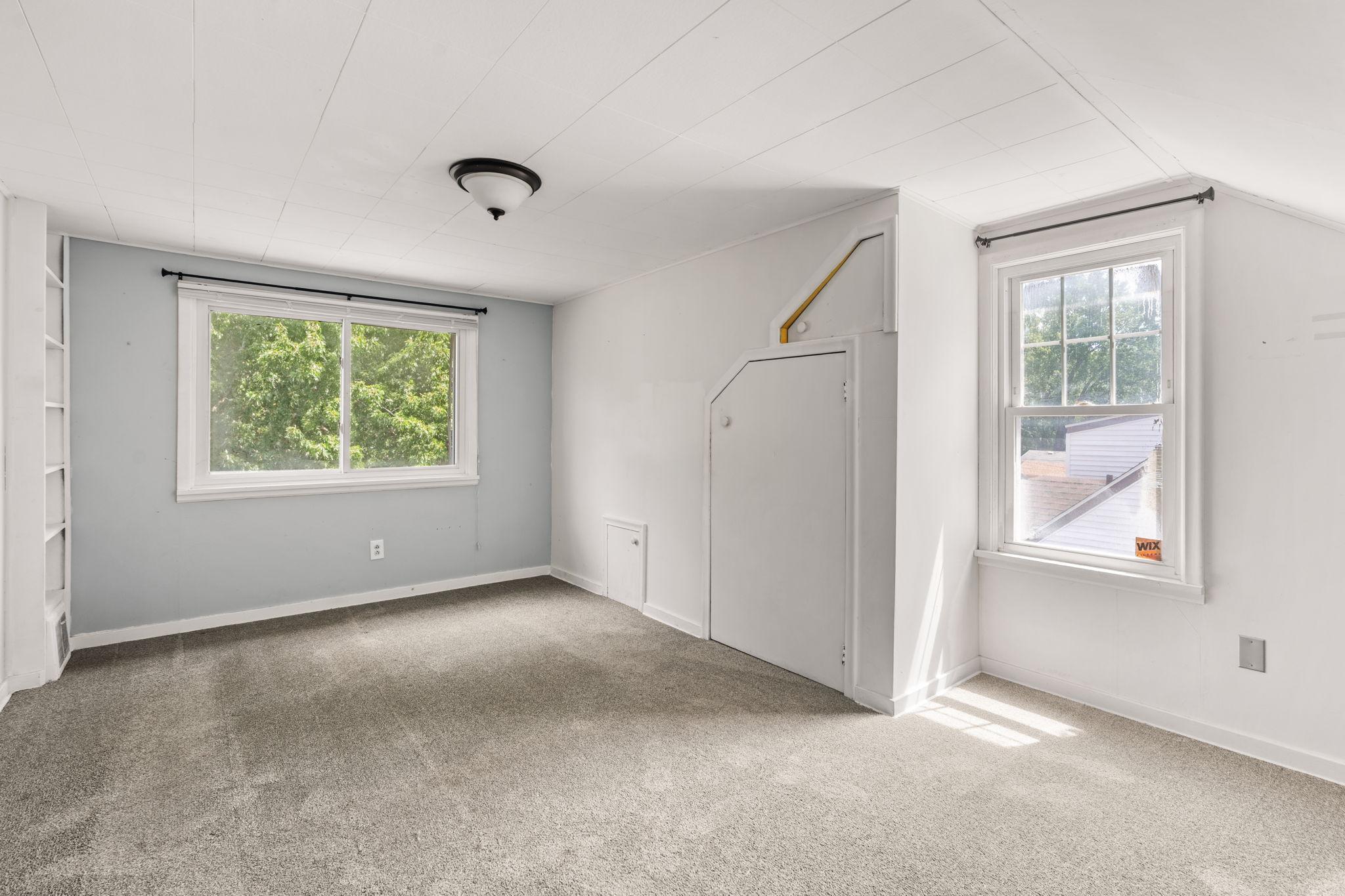 Generously sized upper-level room with natural light and closet storage.