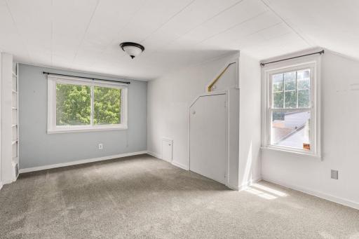 Generously sized upper-level room with natural light and closet storage.