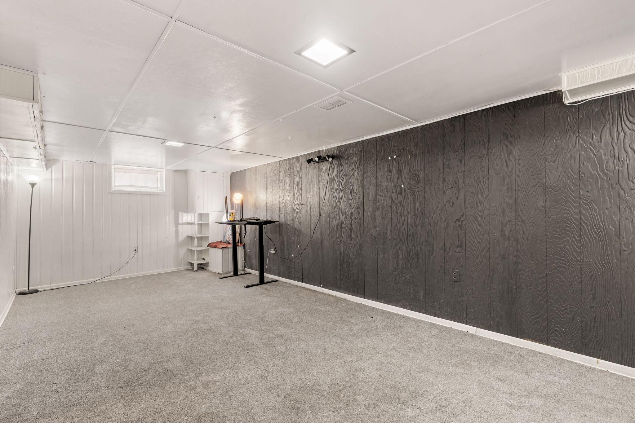 Lower-level flex space ready for a workshop, recreation area, or additional storage.