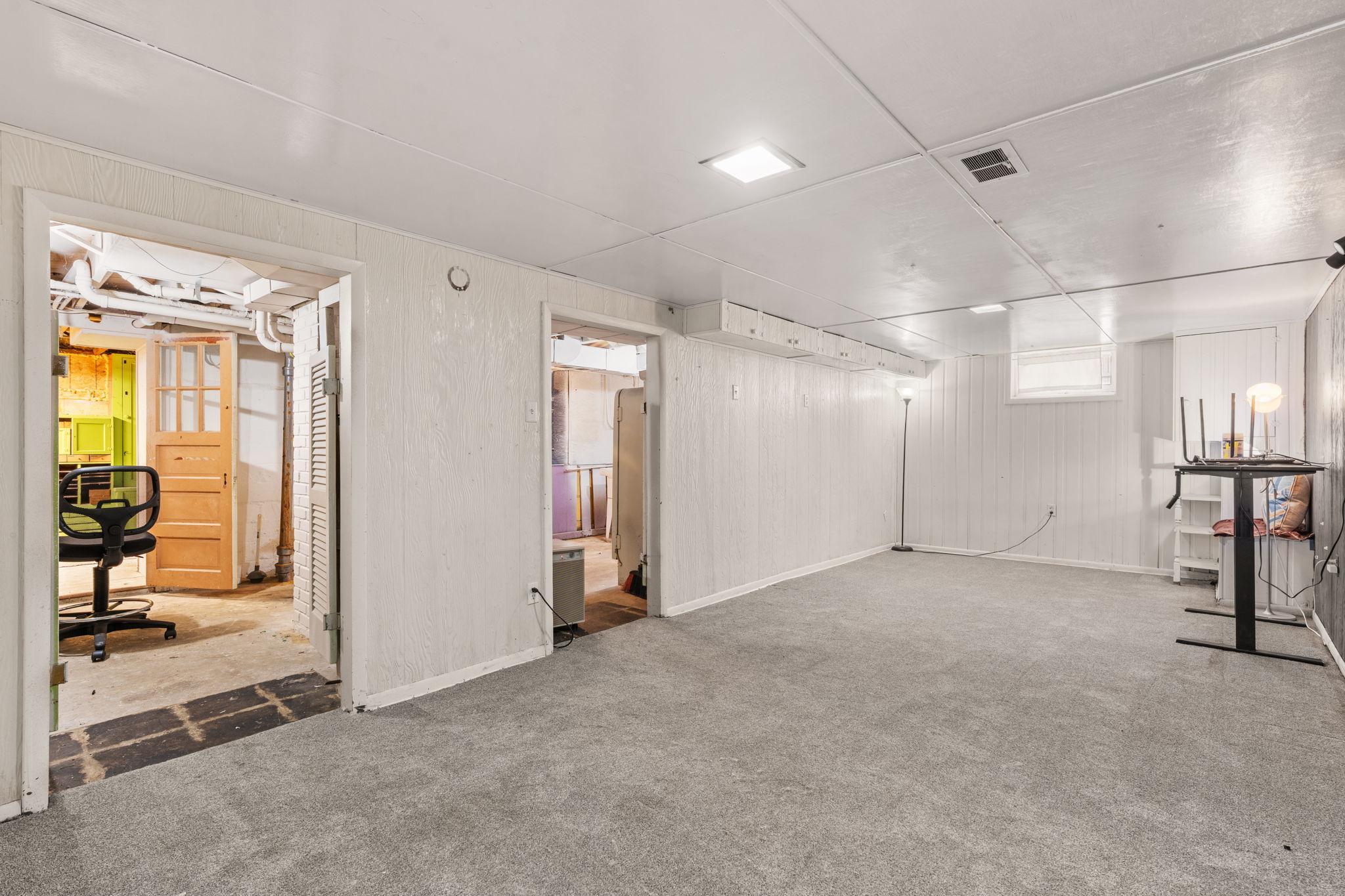 Lower-level flex space ready for a workshop, recreation area, or additional storage.