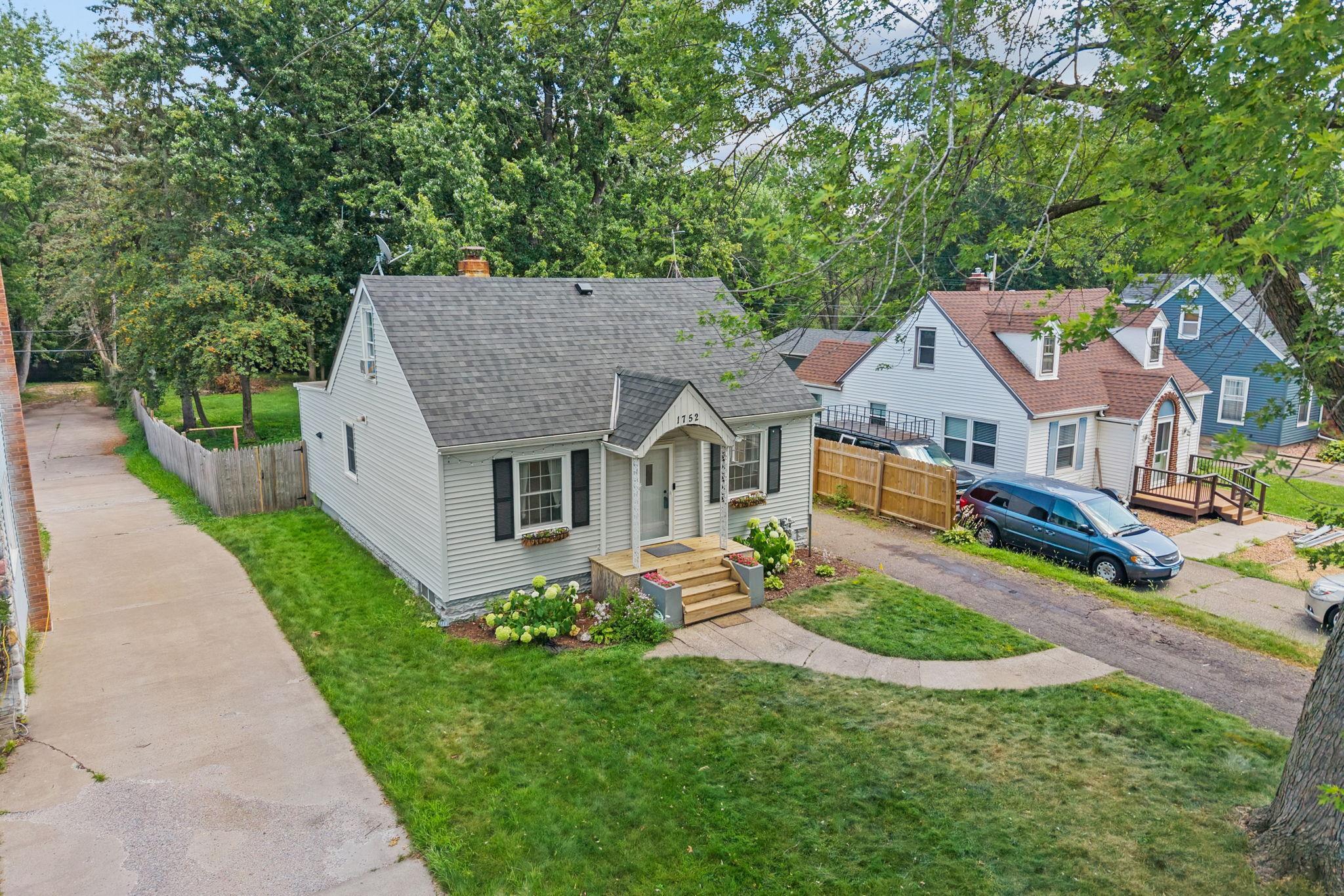 Inviting exterior with major improvements already completed, including a new roof, siding, and gutters.