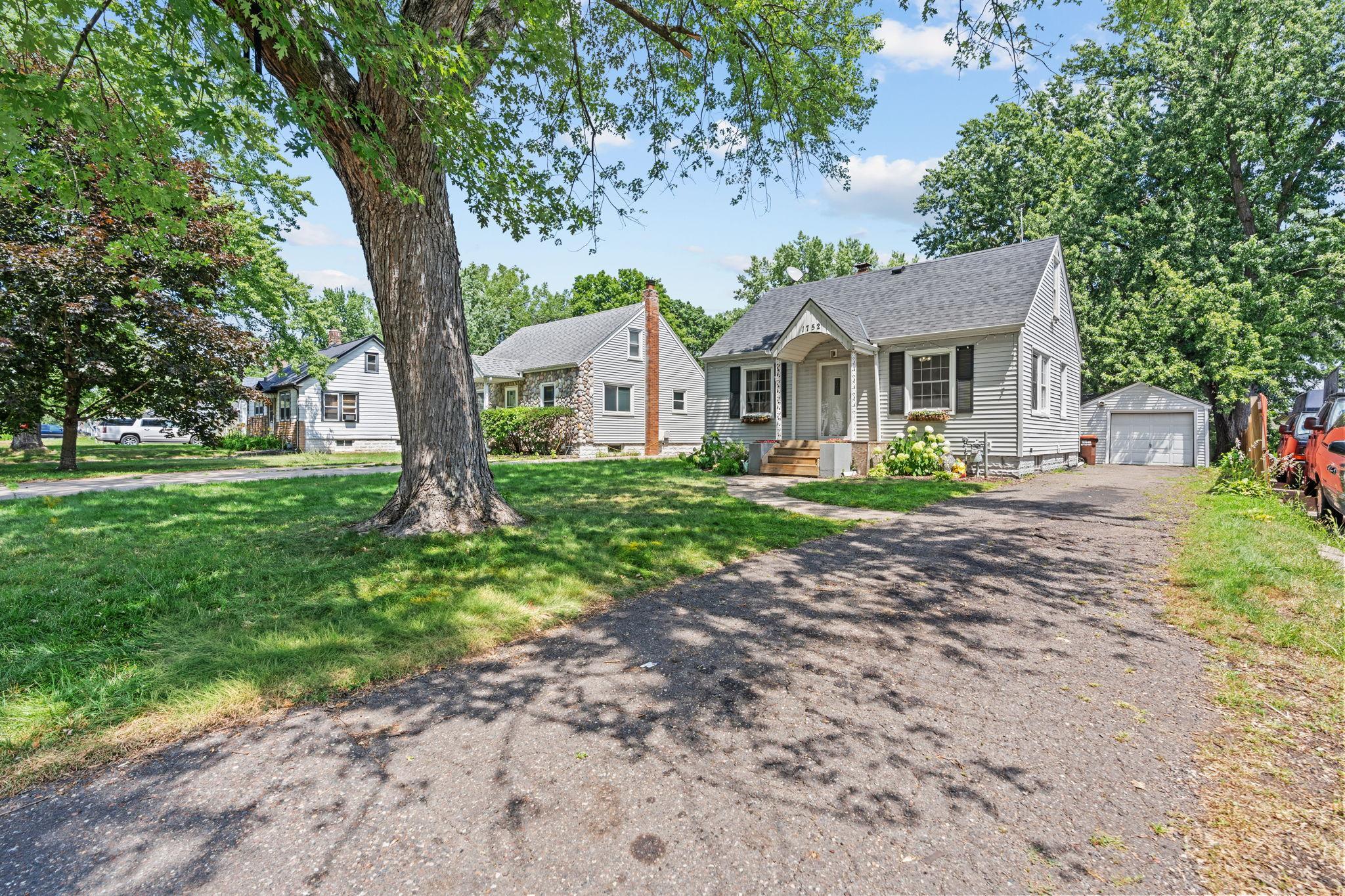 Mature trees provide shade and character while framing the home’s refreshed exterior.