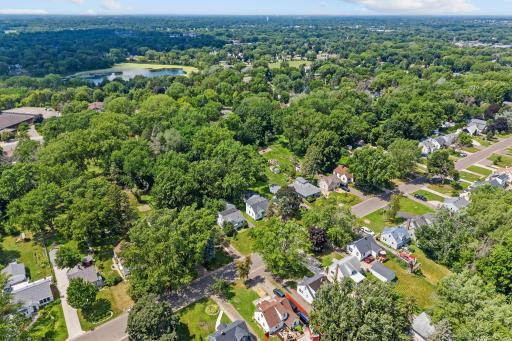 Aerial perspective highlights the new roof, exceptionally deep lot, and surrounding greenery.