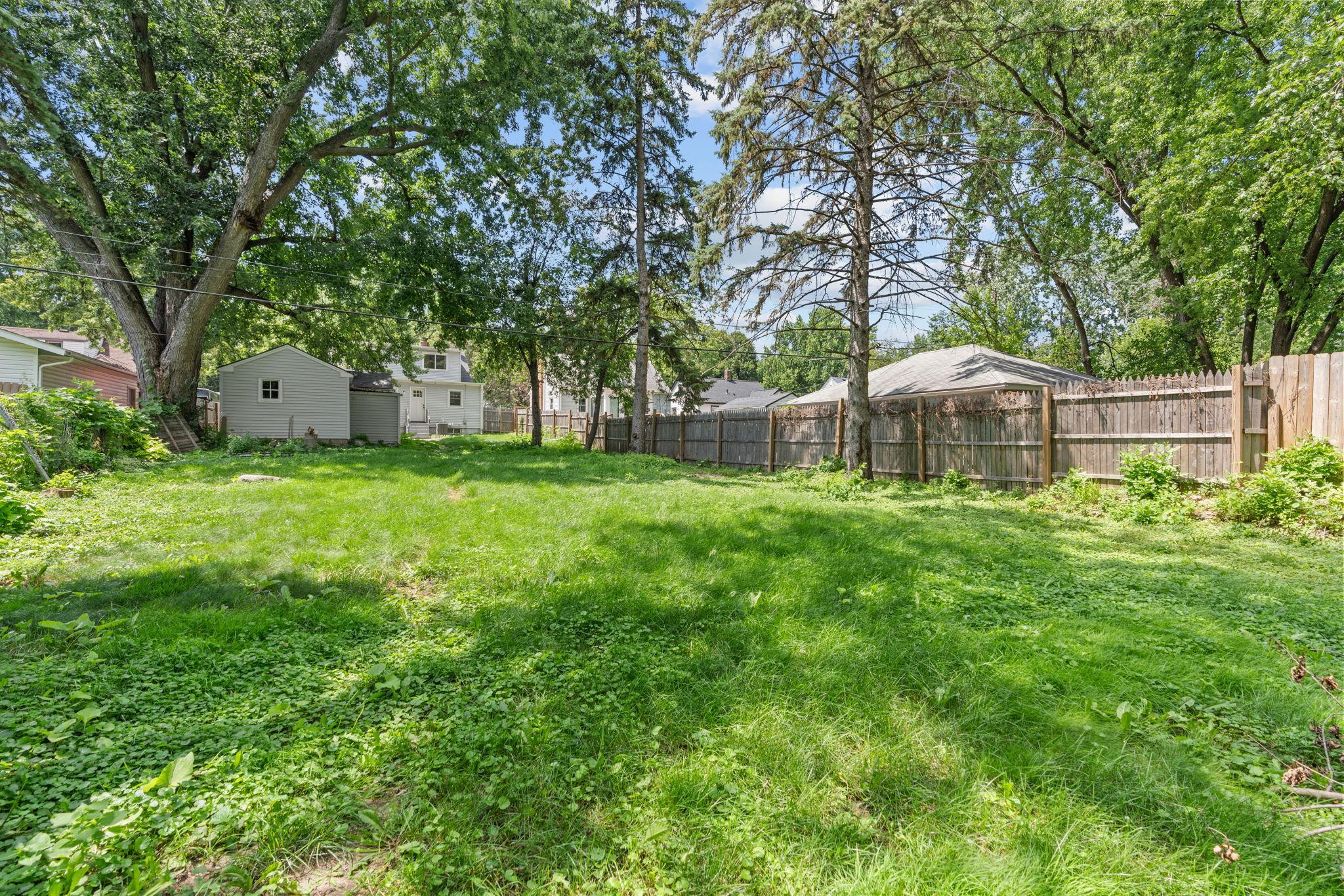 The expansive backyard is a standout feature, offering room to play, garden, entertain, or unwind.