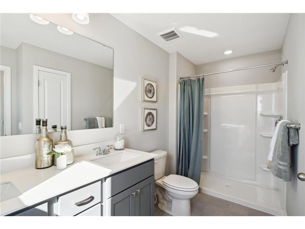 Ensuite bathroom features a double sink and walk in shower