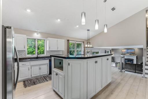 The open floor plan offers a large kitchen with granite counters.