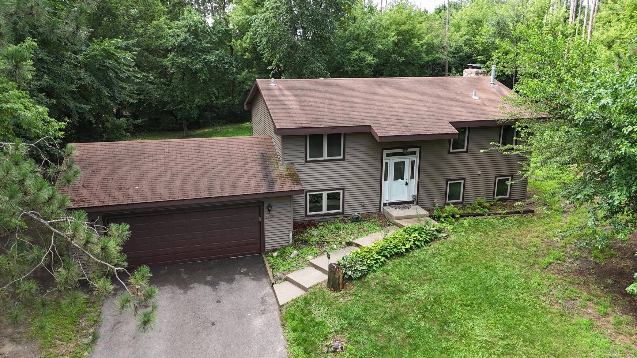 Aerial -attached 2-car garage w/asphalt driveway