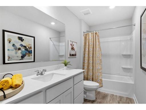 Upper level hall bath serves the secondary bedrooms.