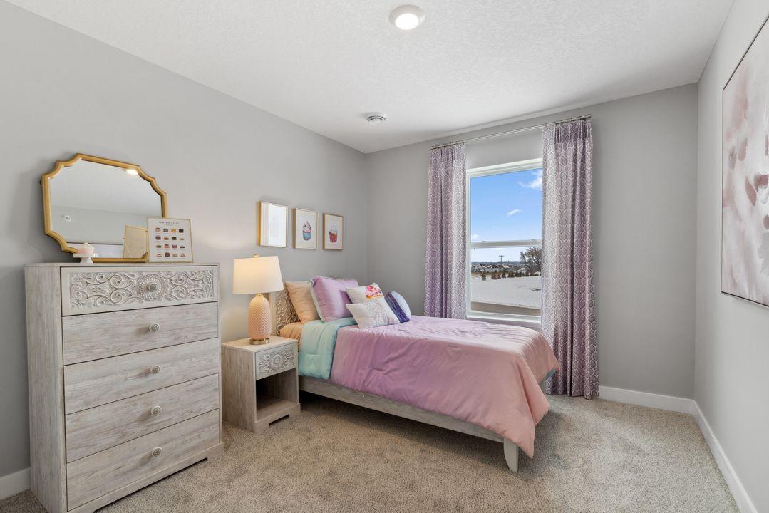Spacious bedroom #3 with lots of natural light. Photo is of model home. Colors and options may vary. Ask Sales Agent for details.