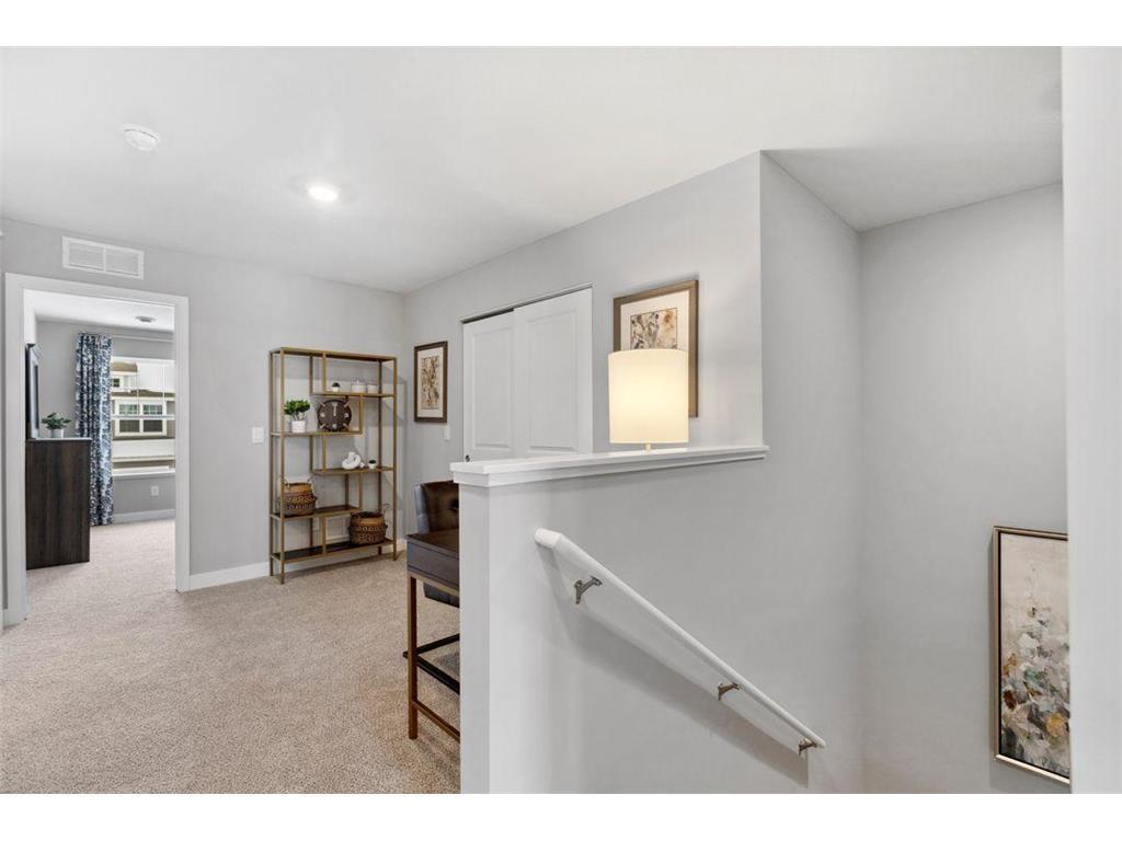 Transition from the main level to the upper level via wide staircase.