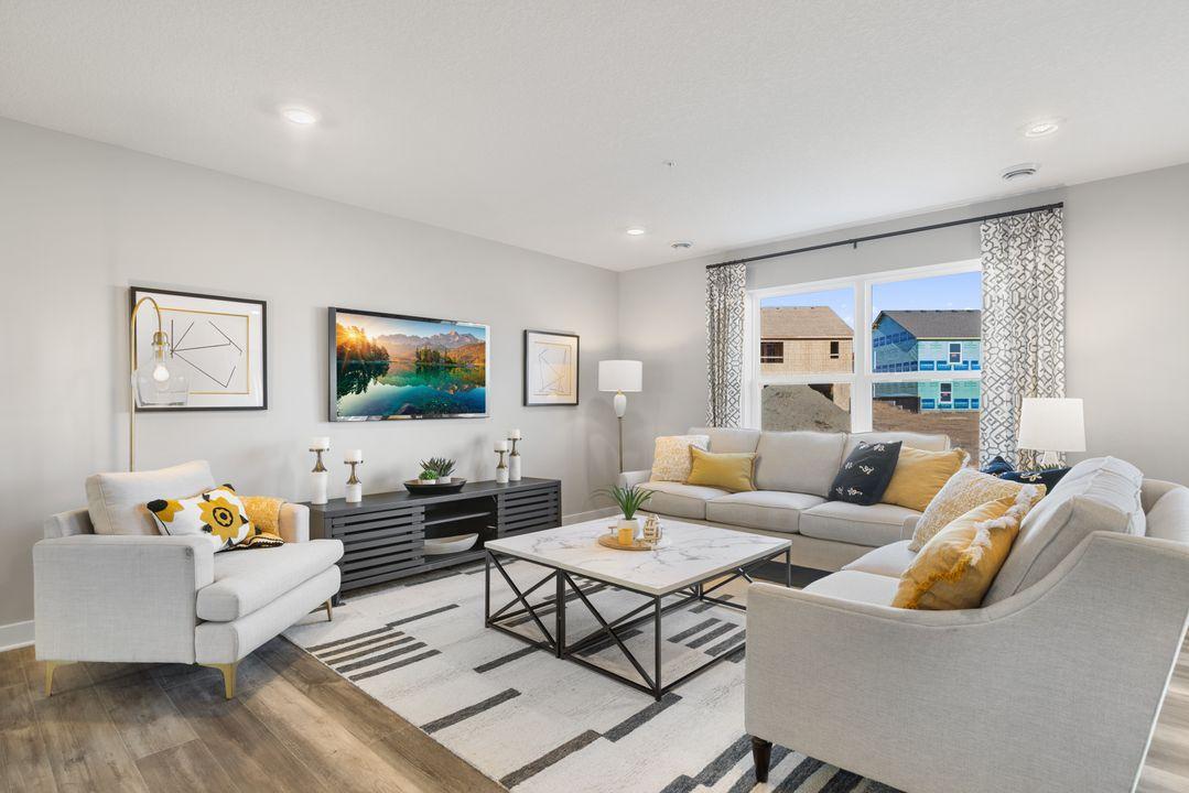Another view of the wide-open main floor. Perfect for entertaining. Photo is of model home. Colors and options may vary. Ask Sales Agent for details.