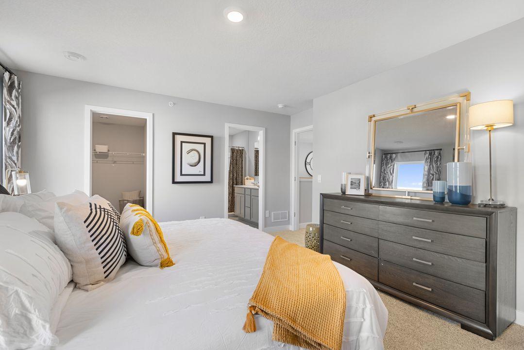 Owner's suite with bathroom en-suite. Photo is of model home. Colors and options may vary. Ask Sales Agent for details.