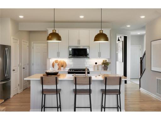 Model photos of the same floorplan. Stainless steel appliances