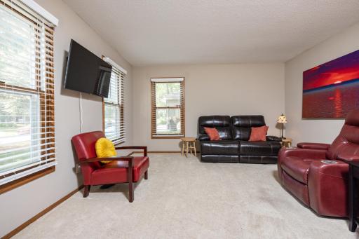 Comfortable living room with a view of the front yard patio and beautiful landscaping
