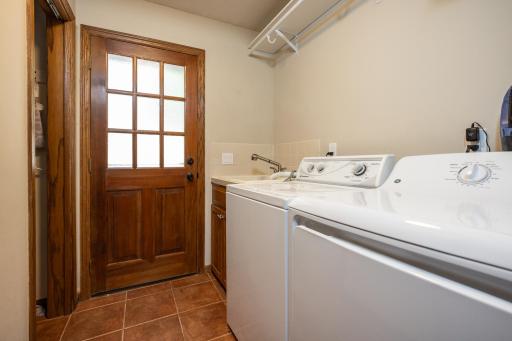 The main floor laundry room has a convenient door out to the pool area