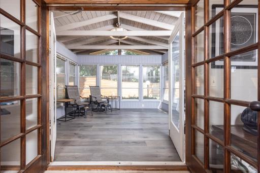 The main floor family room leads to the expansive three season porch