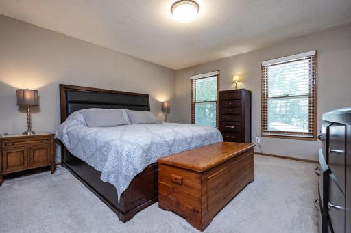 Large primary bedroom suite on the upper level with a wall of closets and a private ensuite bathroom