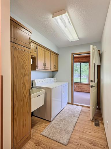 Nice laundry room, with custom cabinets and wash tub.