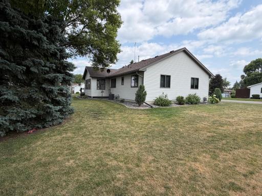 Back yard is level, with mature trees.