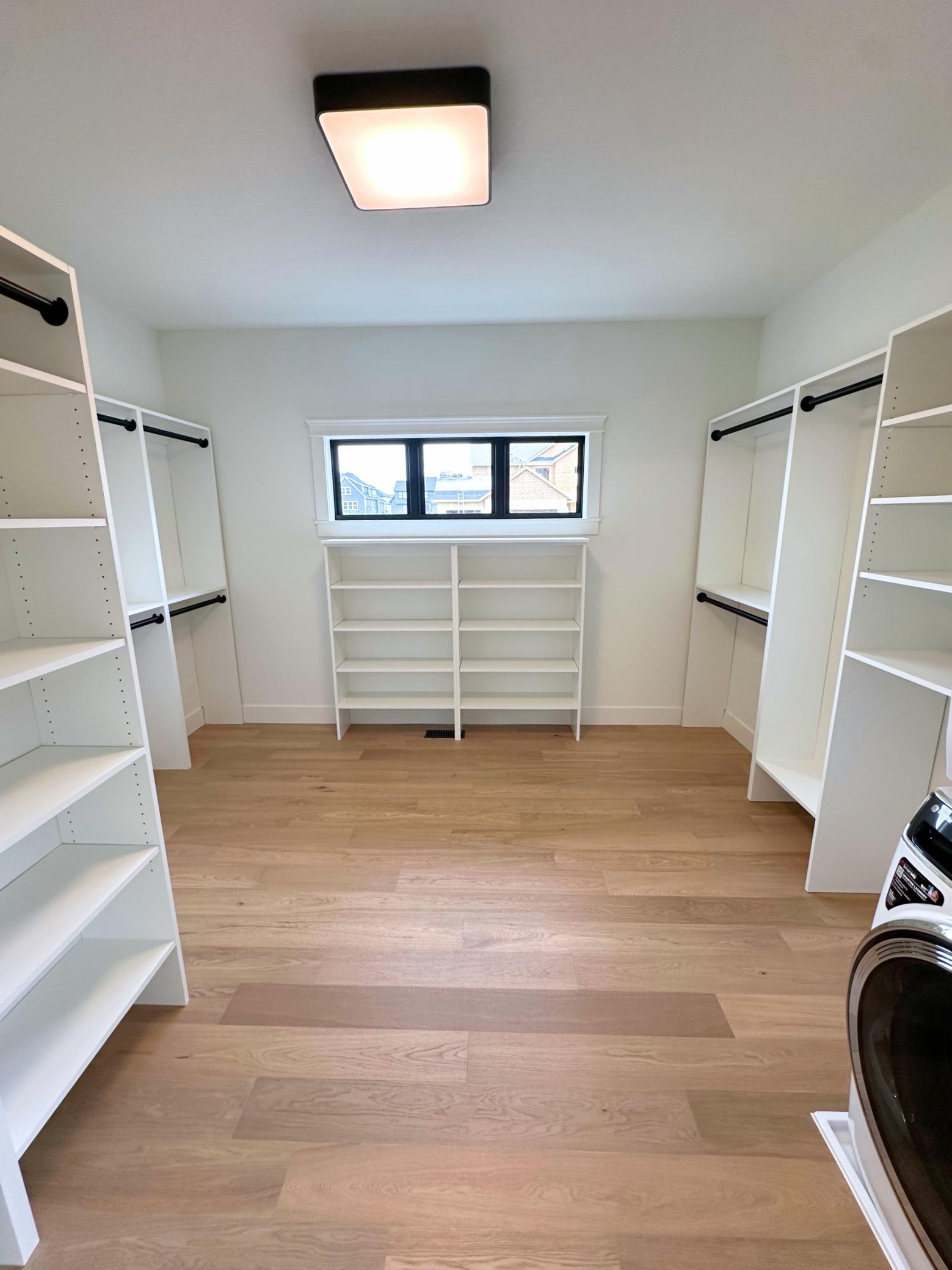 Primary Walk-In Closet w/ Stacked Washer/Dryer