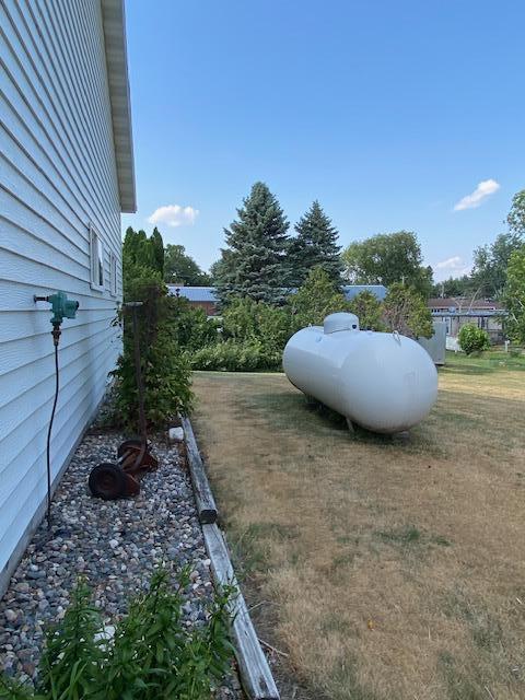 behind garage/shop tank owned