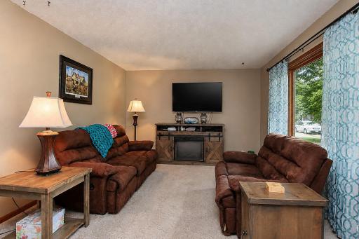 Living room area lets in lots of daylight with the big front window