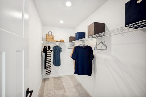 The closet in the owner's bedroom has plenty of space for your entire wardrobe and the built in shelves will make moving in easier *Photo of actual home