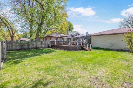 Huge Private Back Yard surrounded by perennial flowers and bushes
