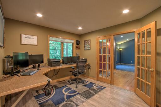 Office with built in desk and new flooring.