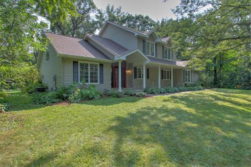 Beautiful hostas surrounding home for a easy lush lanscape.