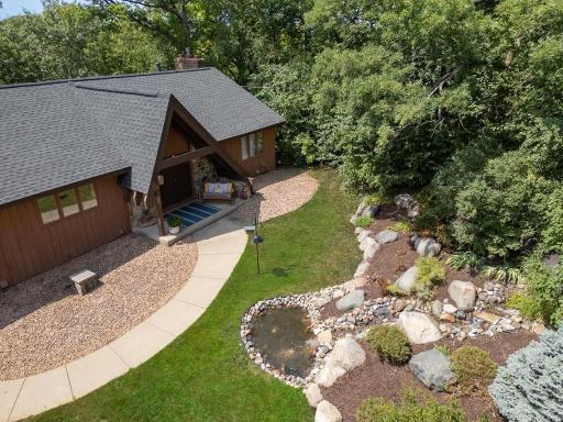 On the way to the front door you will love and look at the absolutely beautiful beautiful rock garden and fountain. In this photo you can also get a look at the new roof installed in 2022.