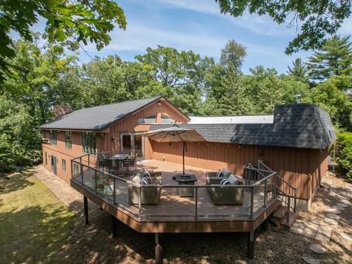 An important feature--his deck is large enough to accommodate all your entertainment and personal needs and also notice the railings and glass not blocking your views of nature and the lake views through the trees and there is a gas line for a grill.
