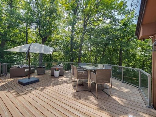 This sun splashed deck can handle all of your deck furniture needs and still leave a lot of open space. And again, notice how nice these glass railings are.