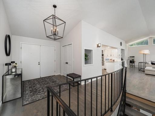 Now the home itself-this photo shows the double width entrance doors and the nice sized entryway and offers a view of the desirable openness and beauty of the main floor. The main floor hardwood floors were installed in 2019.