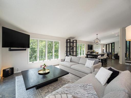 Here is the main floor family room. All of the windows in this photo let in the natural light even on a cloudy day. On a sunny day remember this --you will be amazed at the stunning beauty of the view through the trees of the sparkle from the lake.