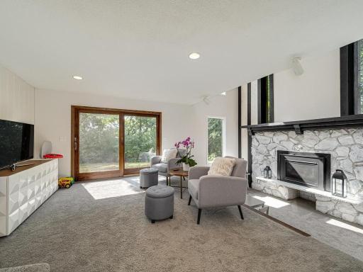 Another walkout lower level family room highlighted by a gas fireplace.