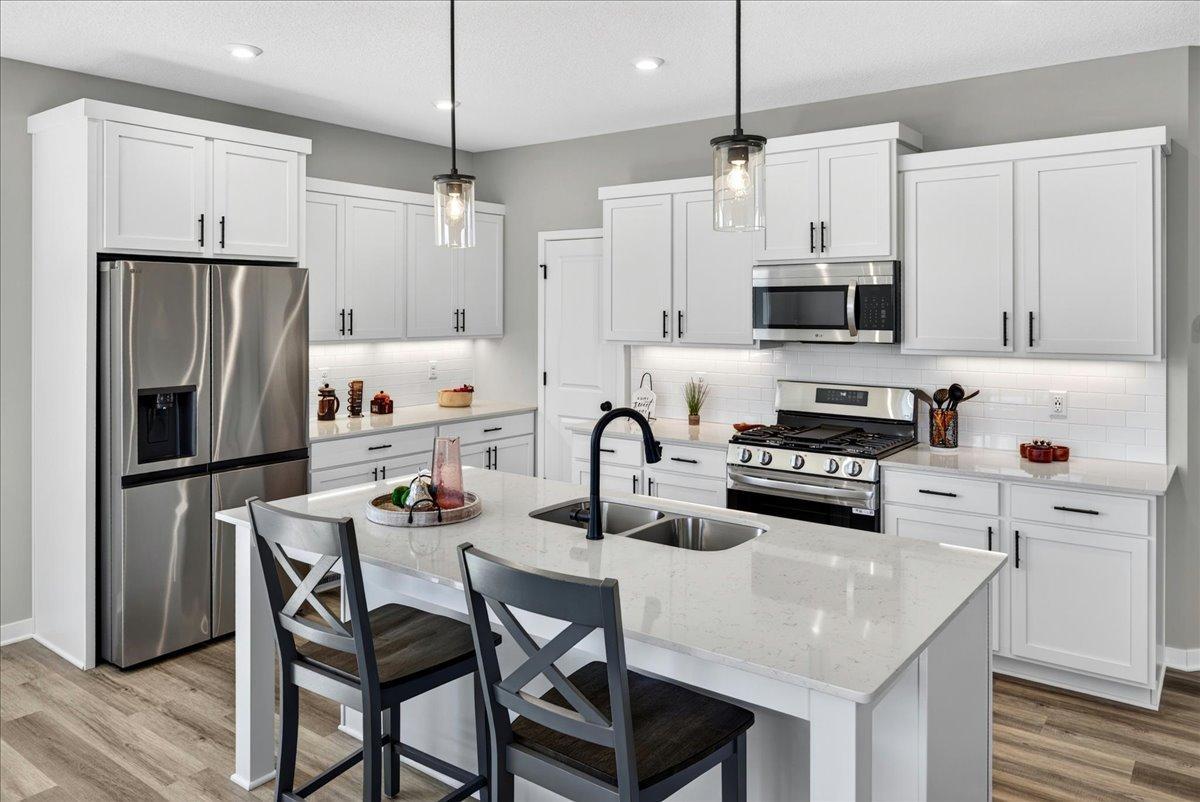 PHOTO OF A DIFFERENT HOME WITH SIMILAR PLAN AND FINISHES.