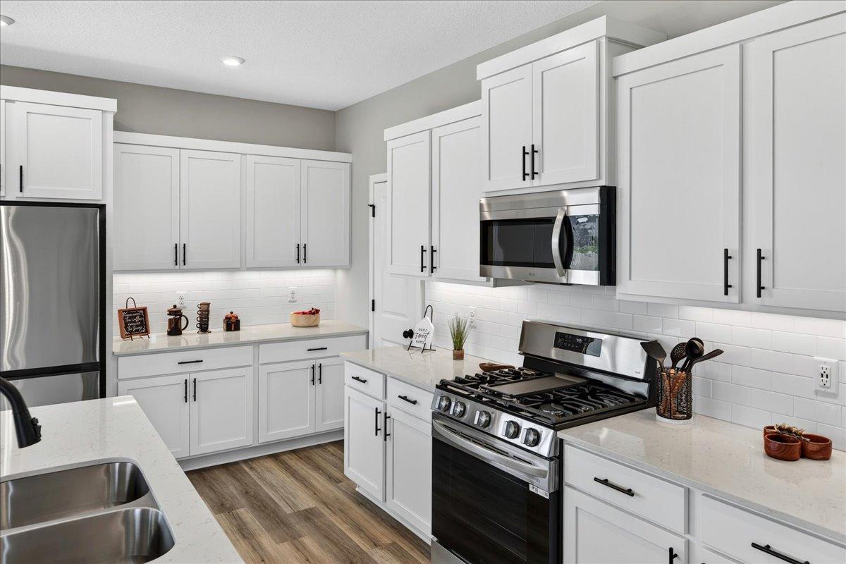 PHOTO OF A DIFFERENT HOME WITH SIMILAR PLAN AND FINISHES.