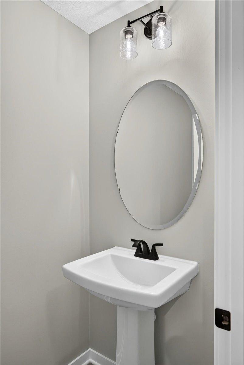 PHOTO OF A DIFFERENT HOME WITH SIMILAR PLAN AND FINISHES. Main Floor Half Bath.